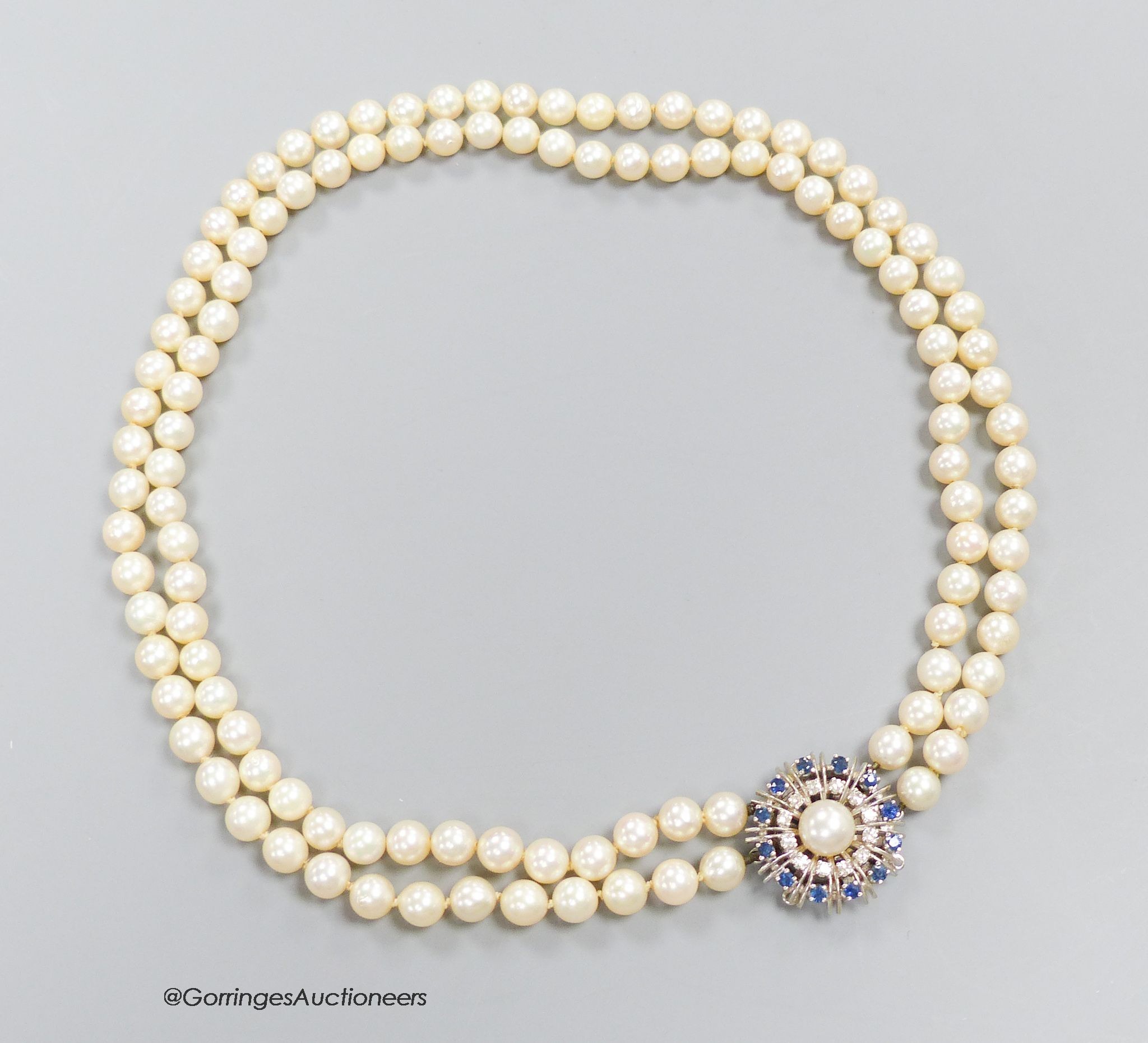 A two strand cultured pearl choker necklace with sapphire and diamond set 14k white gold clasp, length 40cm